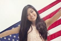A young woman holding an American flag 
