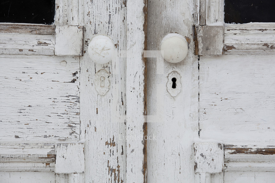 door knobs on an old weathered door 