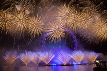 fireworks over a ferris wheel at an amusement park
