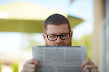 a man reading a newspaper 