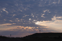 distant cross on a hill 