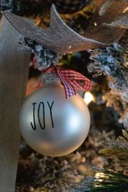 Joy ornament on a Christmas tree