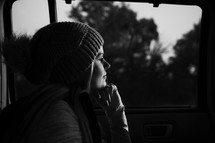 woman looking out a car window 