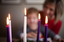 mother and daughter reading a Bible in front of an Advent wreath