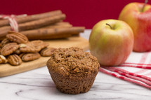 Apple Cinnamon Pecan Muffins on an Apple Red Background