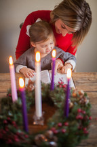 mother and daughter reading a Bible near an Advent wreath 