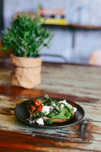food on a plate and house plant on a table 