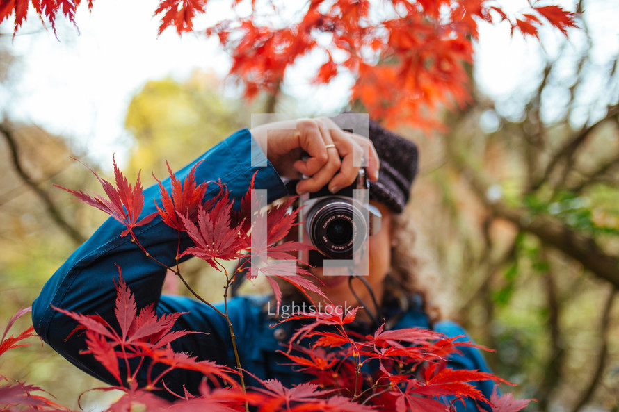 a woman with a camera taking a picture 