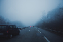 cars driving on a foggy highway 