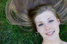 teen girl lying in the grass 