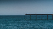 end of a pier in the ocean 