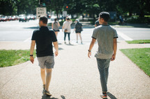 pedestrians walking on a sidewalk 