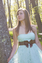 teen girl standing outdoors in a prom dress 