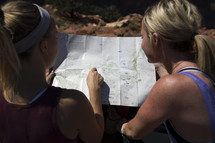 women looking at a trail map 