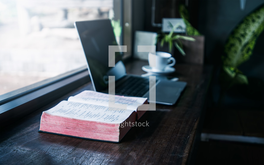open BIble and Laptop on a computer 