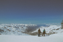hikers at the top of a snow covered mountain 