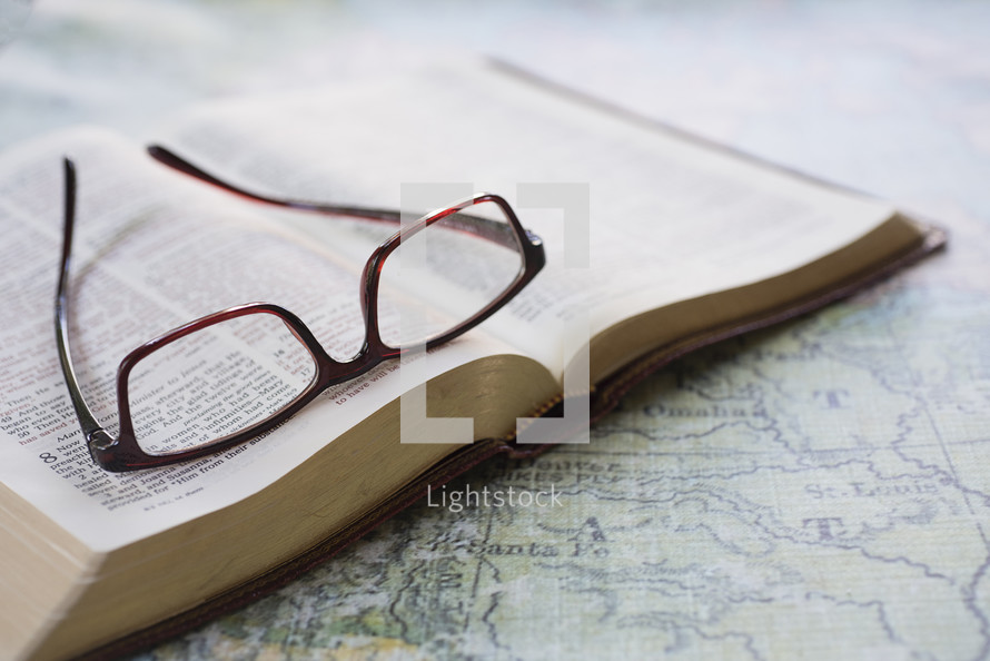 reading glasses on an open Bible 