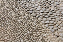 Stone pebbles texture on paved pathway 