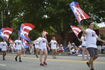 red, white, and blue banners at a parade 