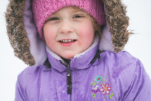 a girl child bundled up in a winter coat 