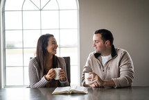 a couple studying a Bible together over coffee 