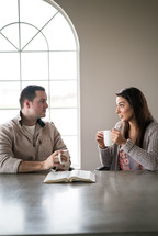 a couple studying the Bible together over coffee 