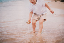 a child playing in the ocean 