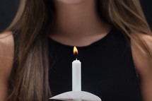 young woman holding a candle 