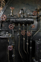 Copper pipes and knobs on a boiler.