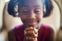an African American girl child with praying hands 