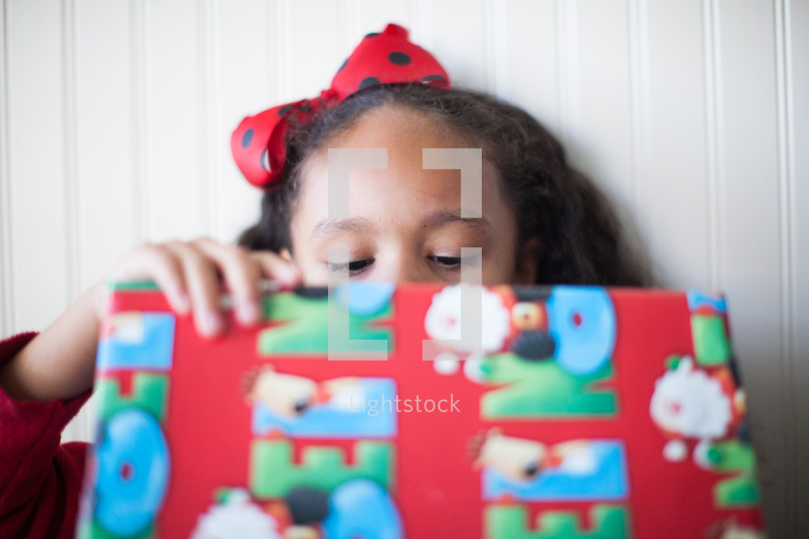 a child opening a Christmas present 