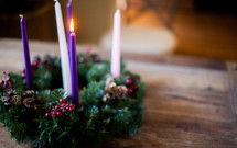one candle lit on an Advent wreath 