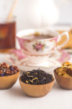 Loose Leaf Tea in a Wooden Bowl, tea cup, and honey 