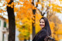 young woman in a park surrounded by autumn colors 