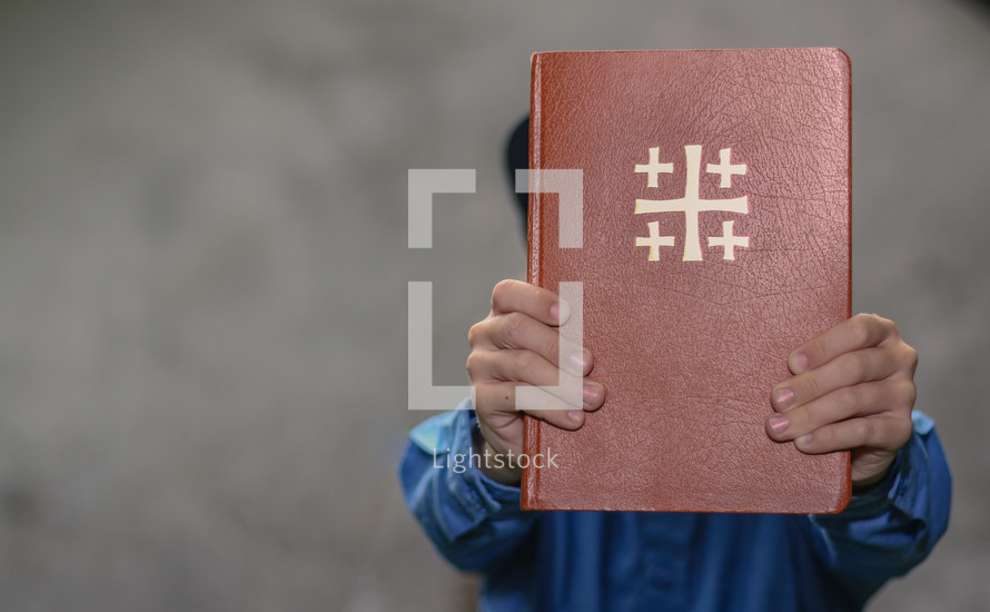 a man holding up a Bible 