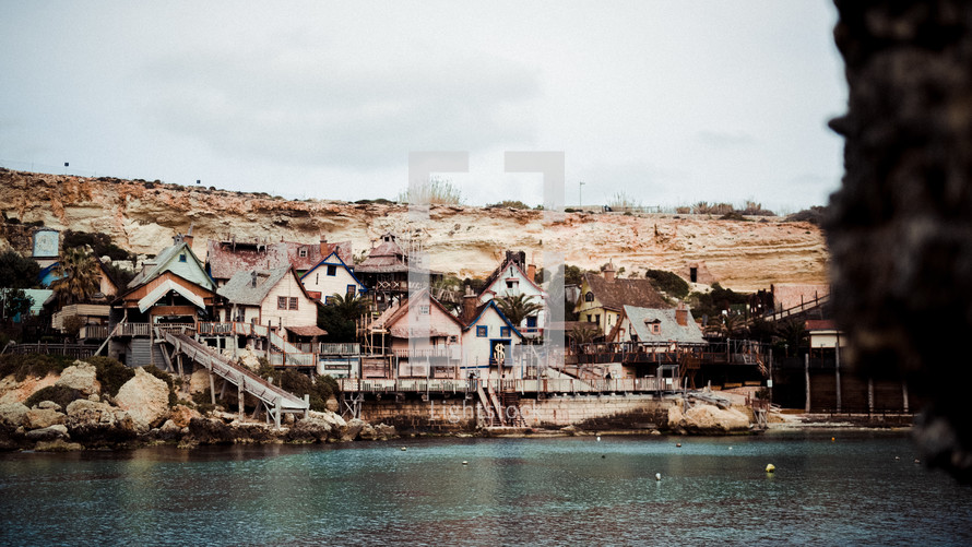 houses built into cliffs along a shore 