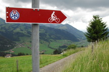 sign pointing the way to a bike trail 