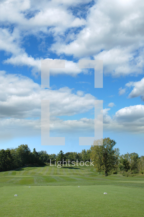Golf course under the clouds.