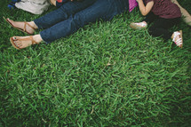Mother, son, and daughter lying in grass