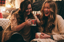 friends laughing in conversation over hot cocoa 