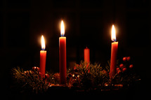 three candles burning on an advent wreath 