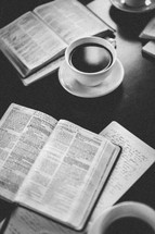 open Bibles and a coffee mug