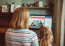 mother and daughter watching an online worship service 