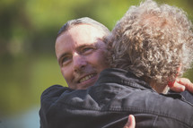men hugging after being baptized 