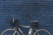 a bike leaning against a brick wall 
