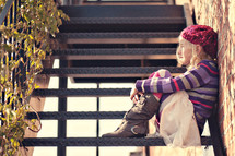girl child sitting on stairs outdoors