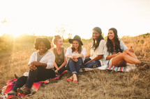 friendship, friends, young woman, african american, woman, college, outdoors, sitting, hill, sunset, blankets, grass