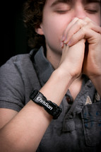 Teen boy praying.