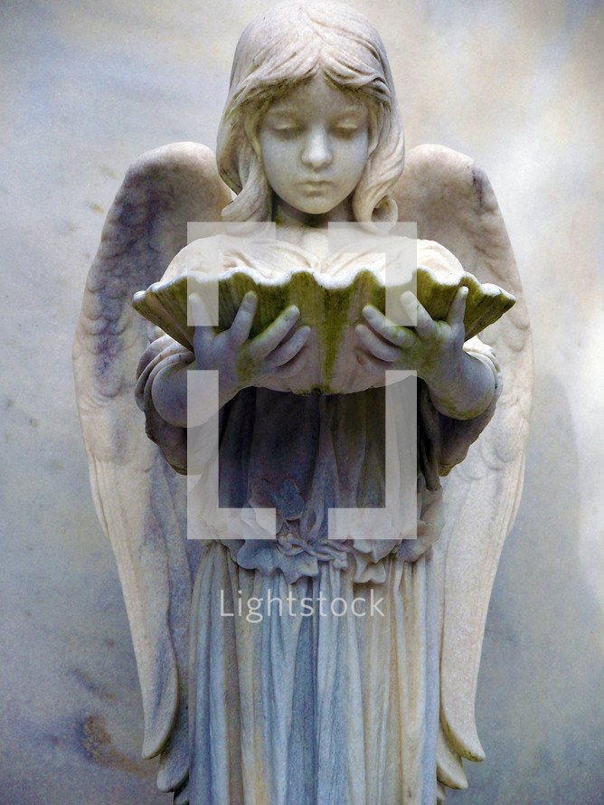 This statue of an angelic girl with wings is in a historic cemetery in the southern United States. 