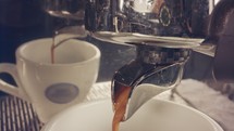 Macro of coffee machine preparing espresso cup